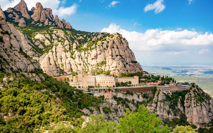 Montserrat Monastery nestled in rugged mountain landscape, Catalonia, Spain.