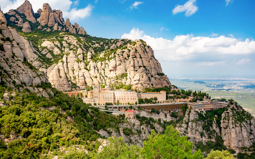 Montserrat Monastery nestled in rugged mountain landscape, Catalonia, Spain.