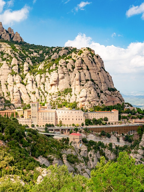 Montserrat Monastery nestled in rugged mountain landscape, Catalonia, Spain.