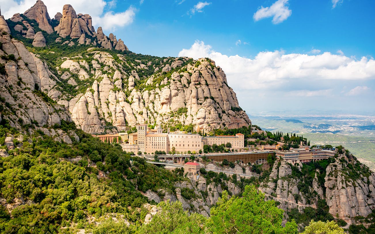 Montserrat Monastery nestled in rugged mountain landscape, Catalonia, Spain.