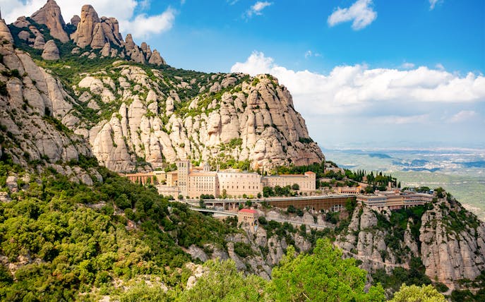 Montserrat Monastery nestled in rugged mountain landscape, Catalonia, Spain.
