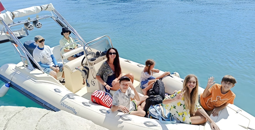 Tourists on a boat for Haxhi Ali Cave tour, Albania, ready to explore the coastal waters.