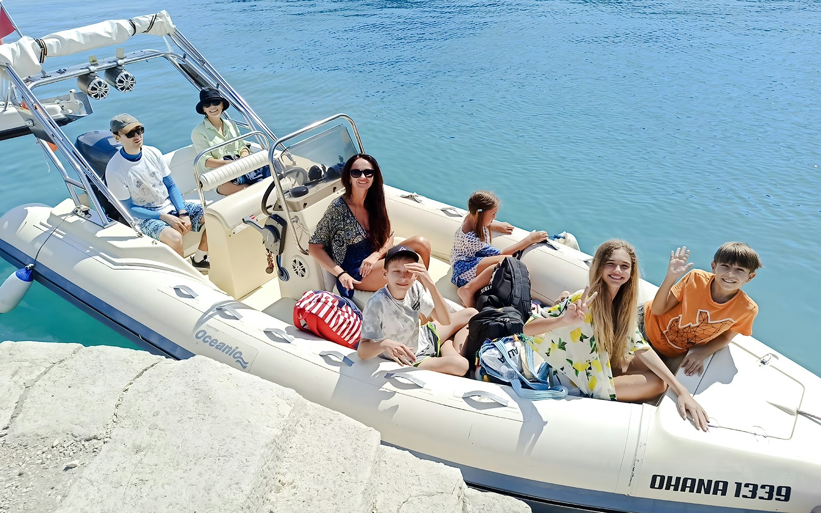Tourists on a boat for Haxhi Ali Cave tour, Albania, ready to explore the coastal waters.