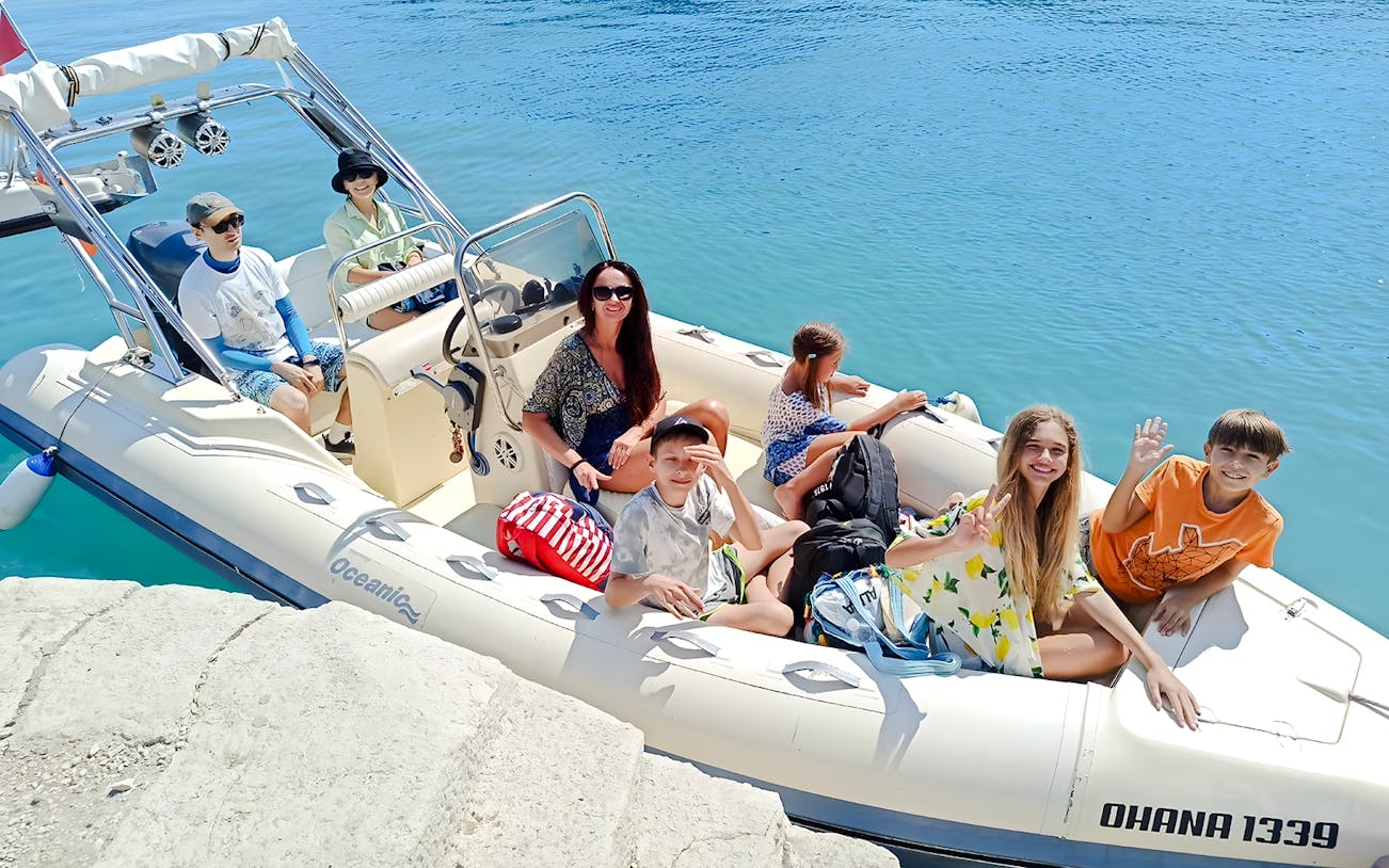 Tourists on a boat for Haxhi Ali Cave tour, Albania, ready to explore the coastal waters.