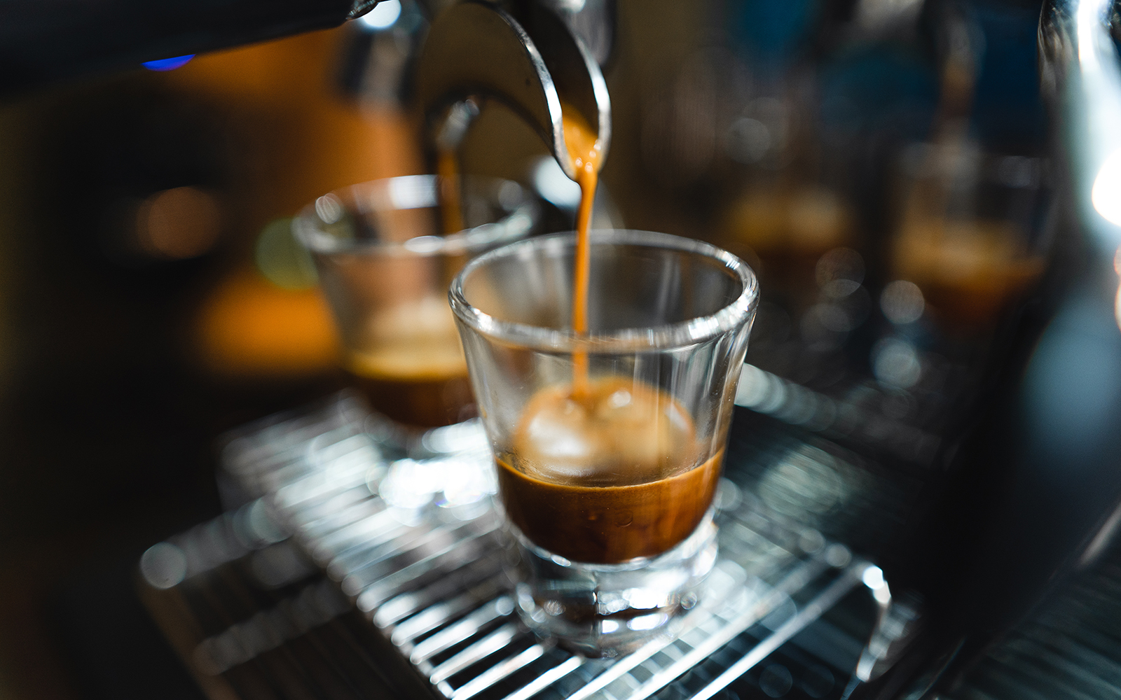 Espresso shot pouring into glass, highlighting single-origin coffee experience.