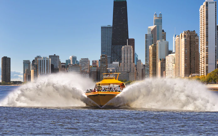 Speedboat on Lake Michigan with Chicago skyline in the background.
