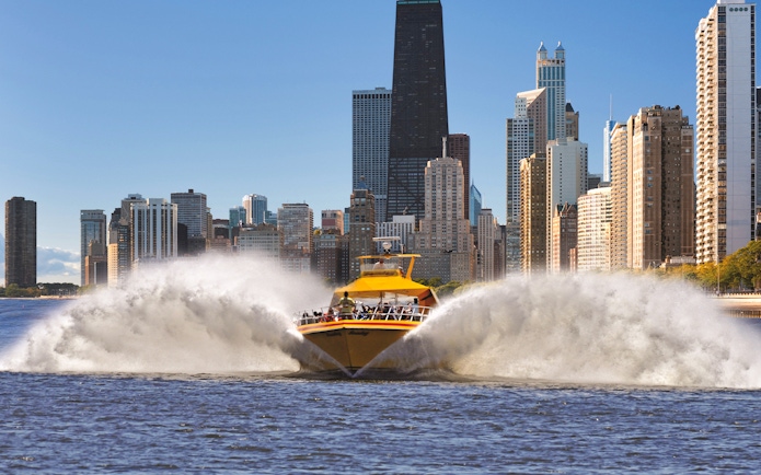 Speedboat on Lake Michigan with Chicago skyline in the background.