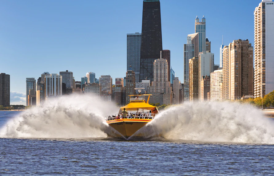 Speedboat on Lake Michigan with Chicago skyline in the background.