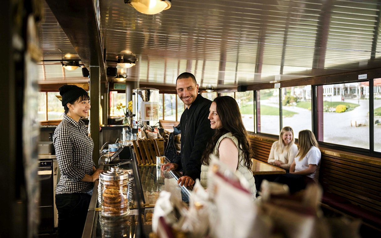 Couple ordering at a cafe on board an old vessel, Walter Peak.