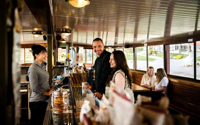 Couple ordering at a cafe on board an old vessel, Walter Peak.