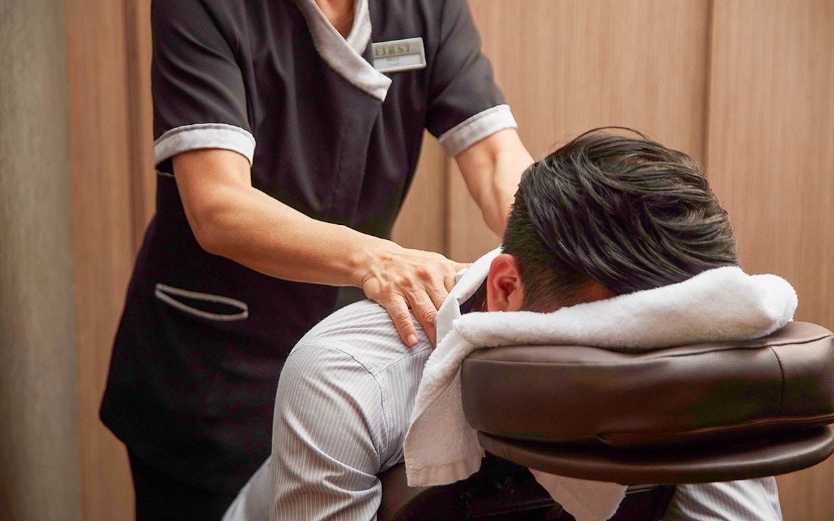 Massage service in first-class lounge at Hong Kong International Airport.