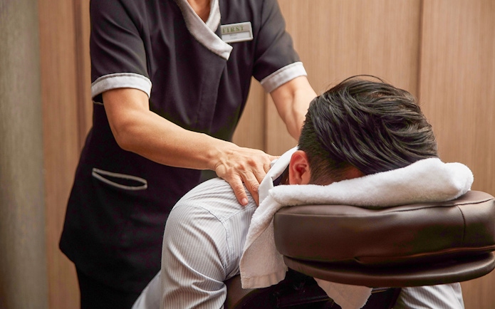 Massage service in first-class lounge at Hong Kong International Airport.