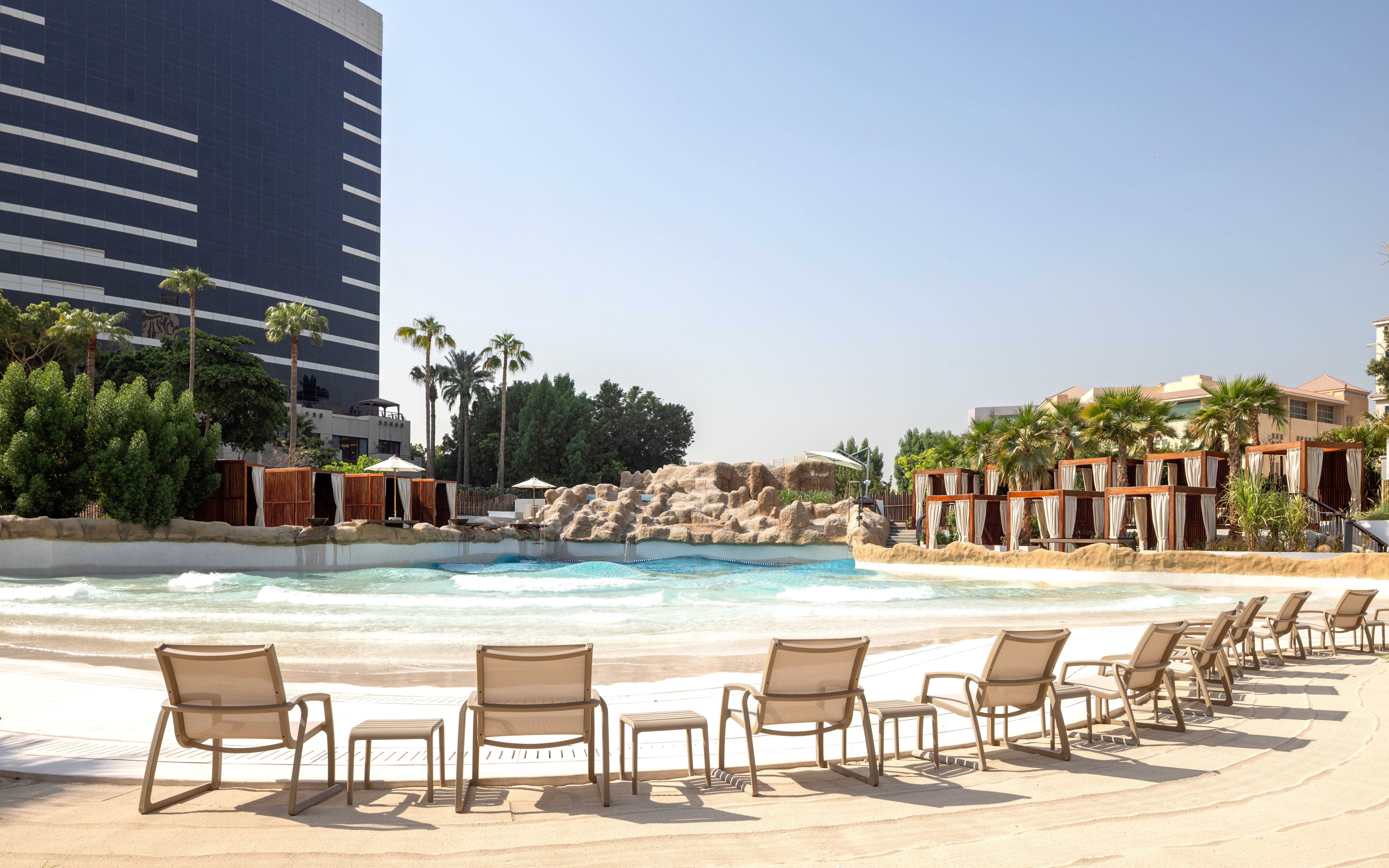 Lounge chairs facing wave pool at Grand Hyatt waterpark, Dubai.