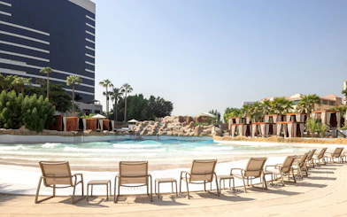Lounge chairs facing wave pool at Grand Hyatt waterpark, Dubai.