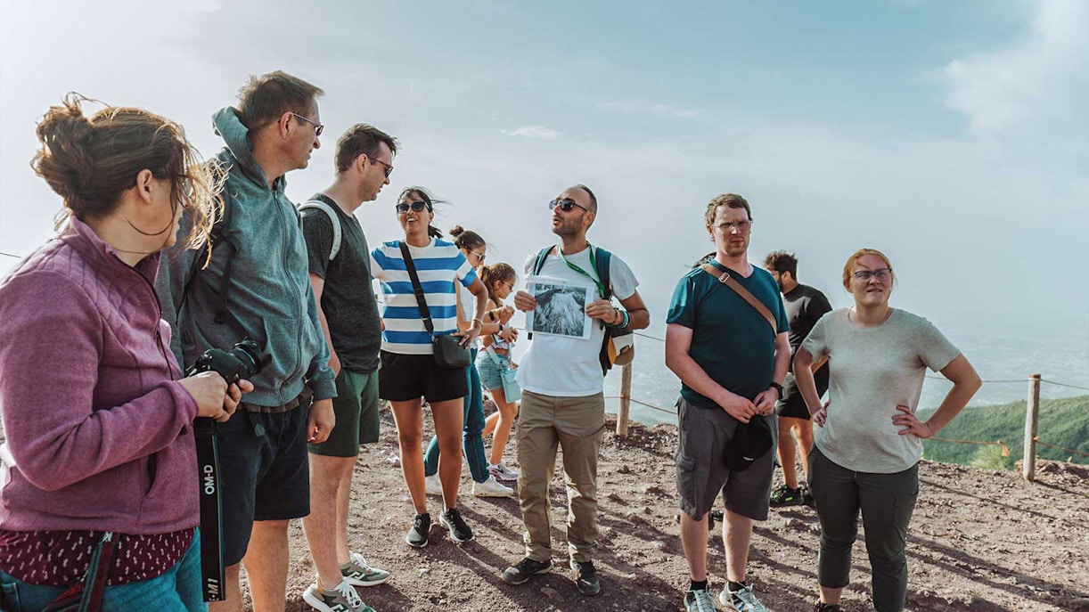 Guide explaining Mount Vesuvius to tourists