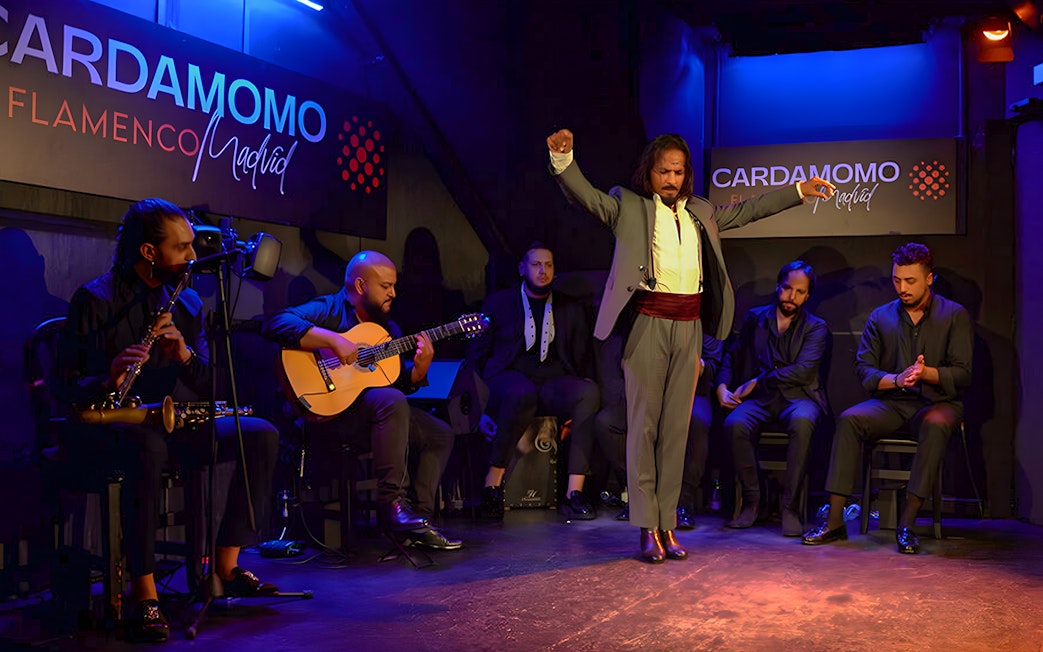 Flamenco performance at Cardamomo in Madrid with musicians and dancer on stage.