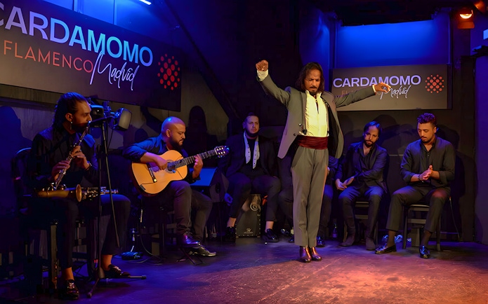 Flamenco performance at Cardamomo in Madrid with musicians and dancer on stage.