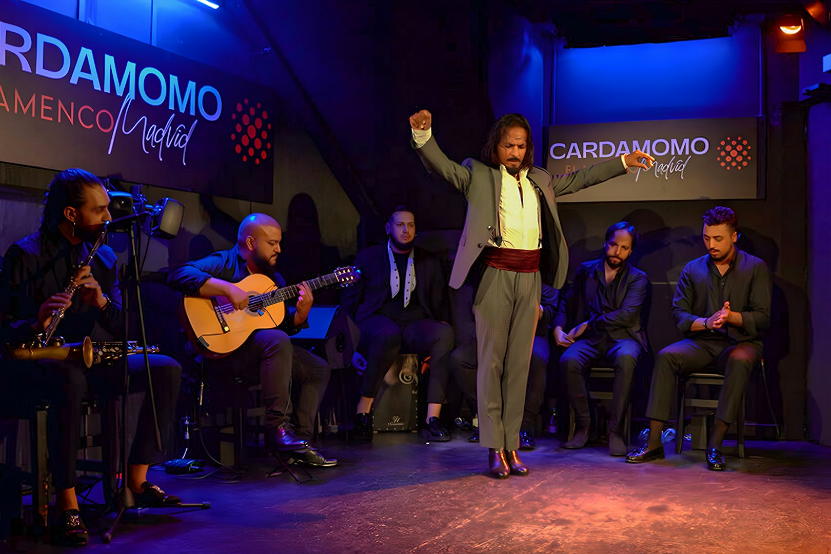 Flamenco performance at Cardamomo in Madrid with musicians and dancer on stage.