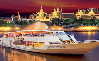 Chao Phraya Princess cruise at night with Bangkok's Grand Palace illuminated in the background.
