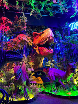Dinosaurs exhibit with vibrant lighting at Wetland Studios Putrajaya.