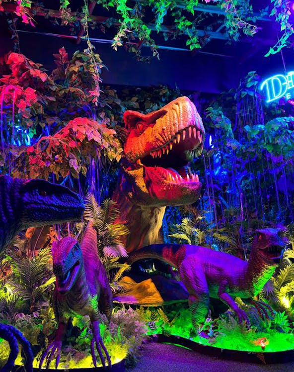 Dinosaurs exhibit with vibrant lighting at Wetland Studios Putrajaya.