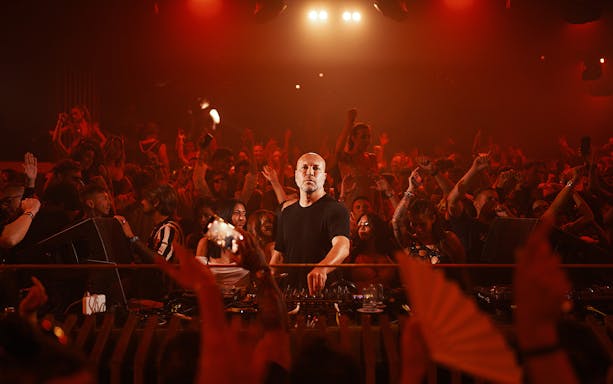 DJ performing at Music On event in Pacha Ibiza nightclub, vibrant crowd enjoying the show.