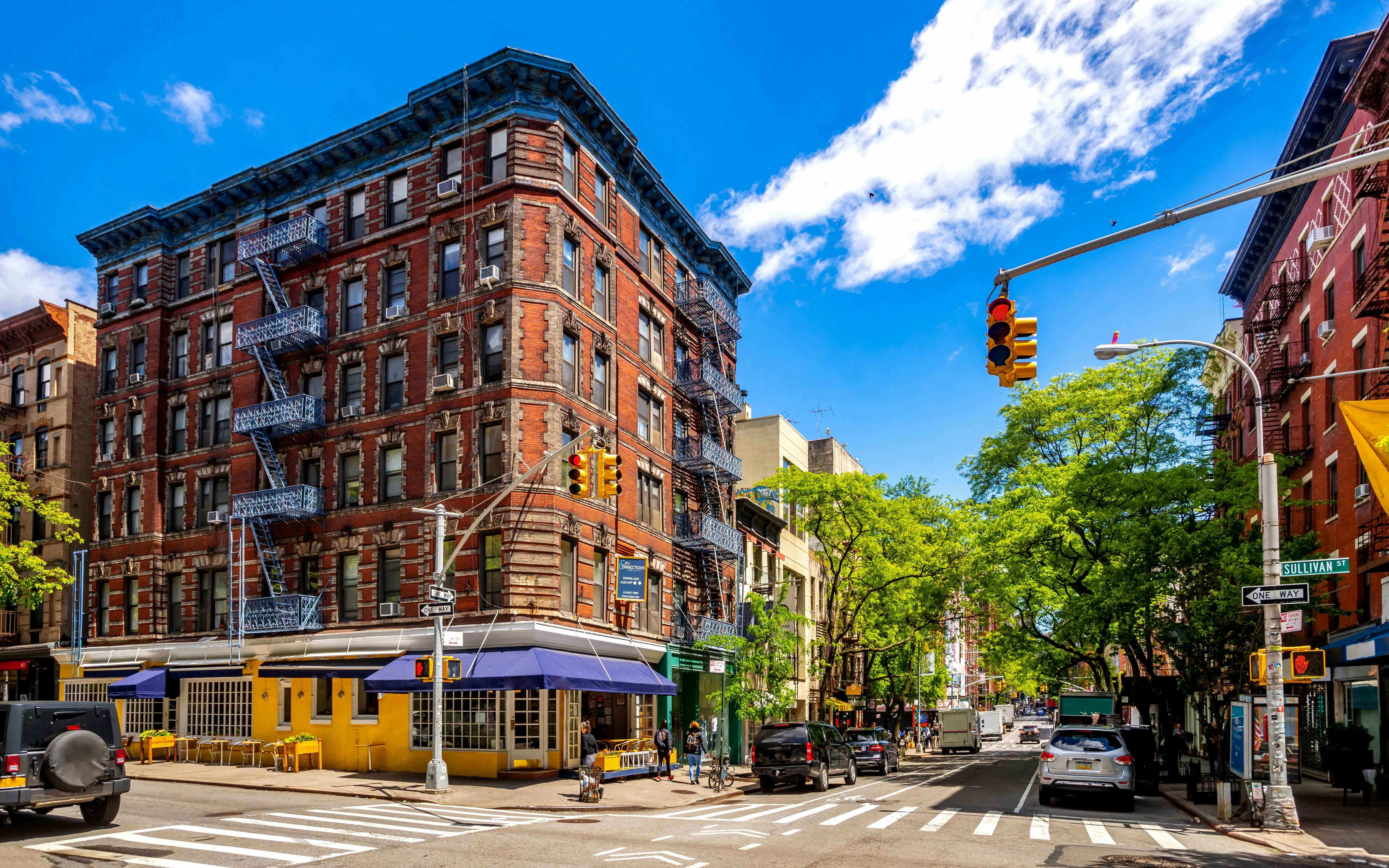 Historic building with fire escapes on Sullivan Street, SoHo, New York City, USA.