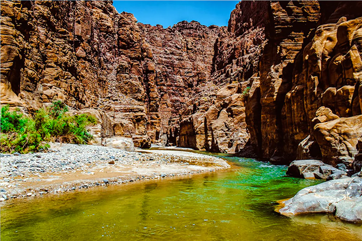 Wadi Mujib Siq Trail canyon with flowing river, Amman adventure hike.