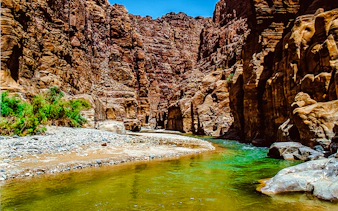 Wadi Mujib Siq Trail canyon with flowing river, Amman adventure hike.