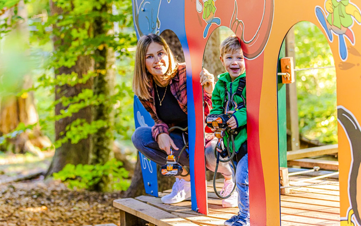 Child and adult enjoying Ropes Park Interlaken adventure course.