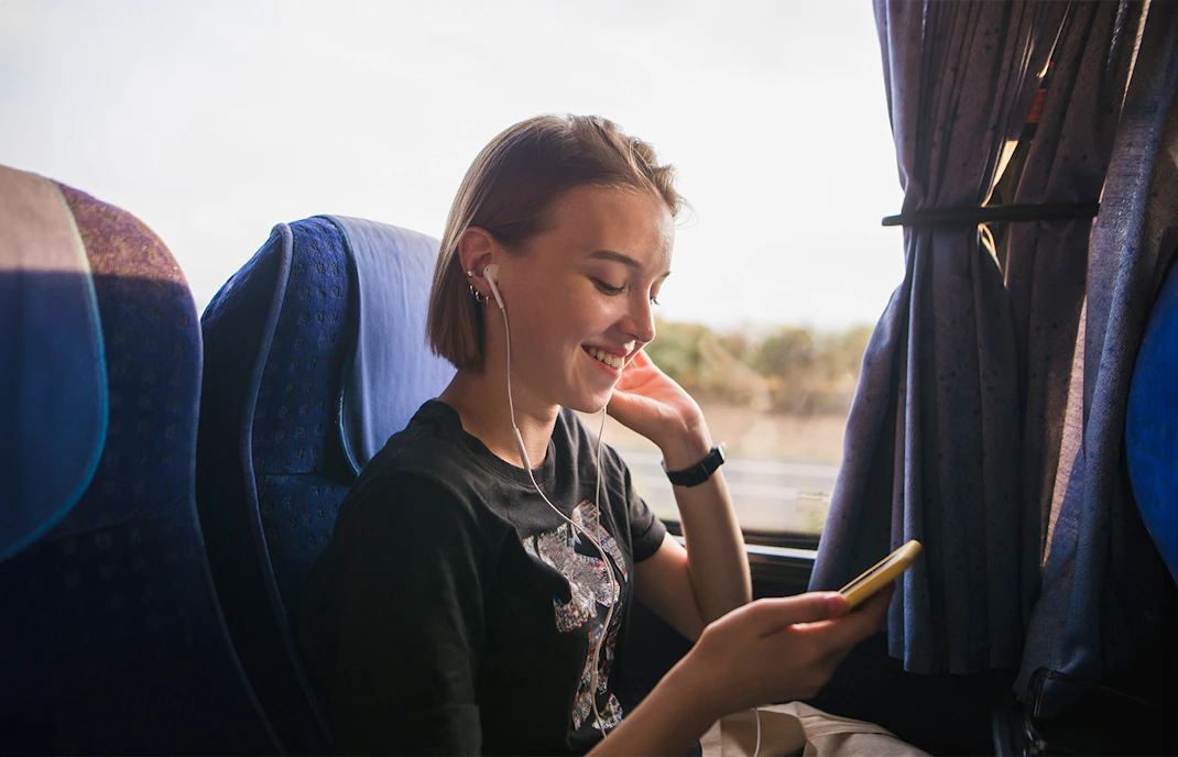 Person listening to music on a coach transfer.