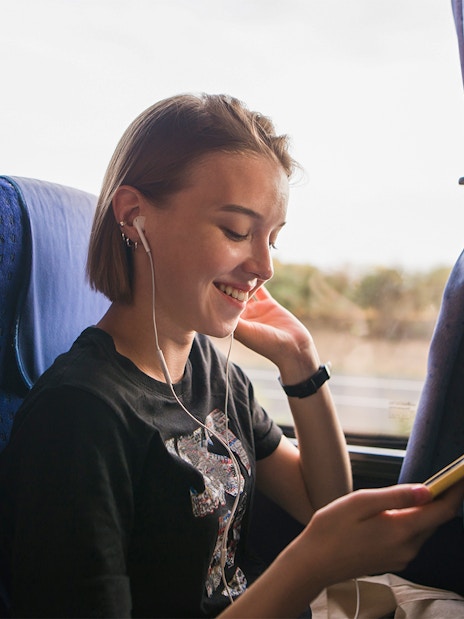 Person listening to music on a coach transfer.