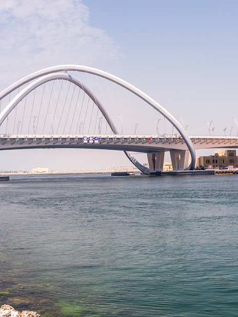 Dubai Creek with Al Garhoud Bridge on a historical tour.