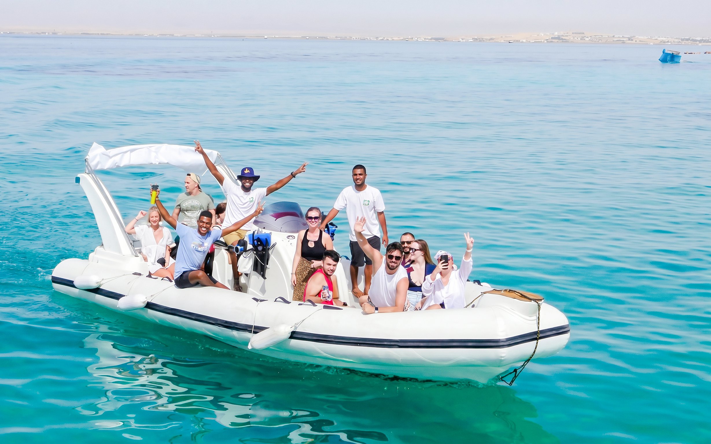 Group enjoying a high-speed sea taxi tour on clear waters near Orange Bay.
