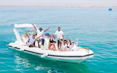 Group enjoying a high-speed sea taxi tour on clear waters near Orange Bay.