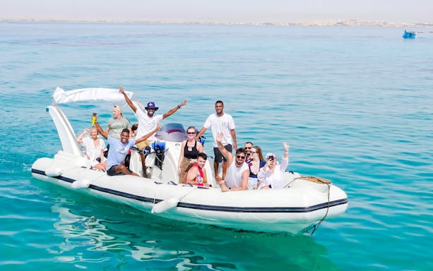 Group enjoying a high-speed sea taxi tour on clear waters near Orange Bay.