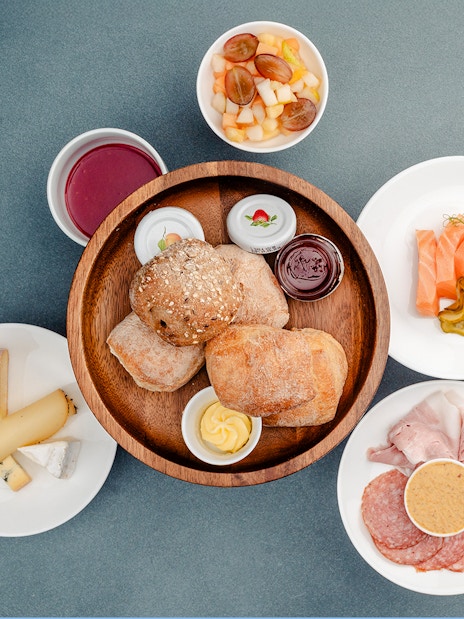 Breakfast spread with bread, cheese, meats, and fruit at Berliner Fernsehturm, Berlin.