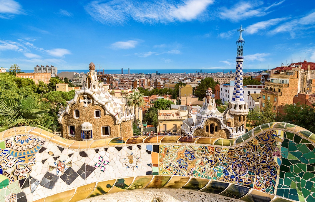 Park Güell mosaic benches with Sagrada Familia in the background, Barcelona.