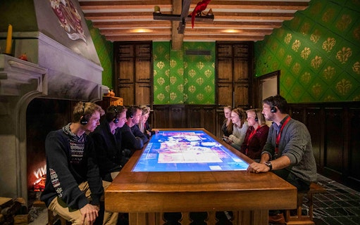 Visitors engaging with interactive display at Historium Bruges, Belgium.