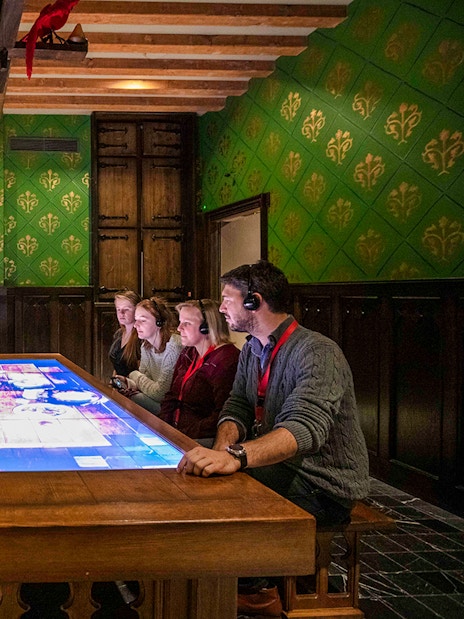 Visitors engaging with interactive display at Historium Bruges, Belgium.