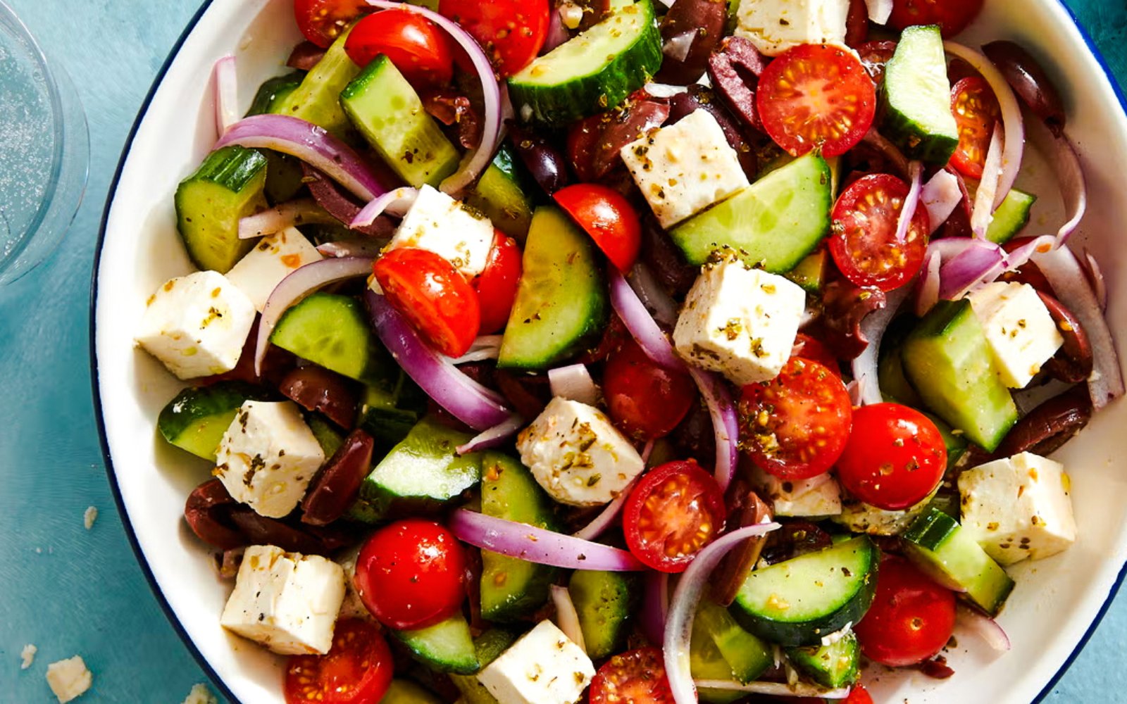Greek salad with feta, cucumbers, tomatoes, olives, and onions served on Catamaran Cruise tour.