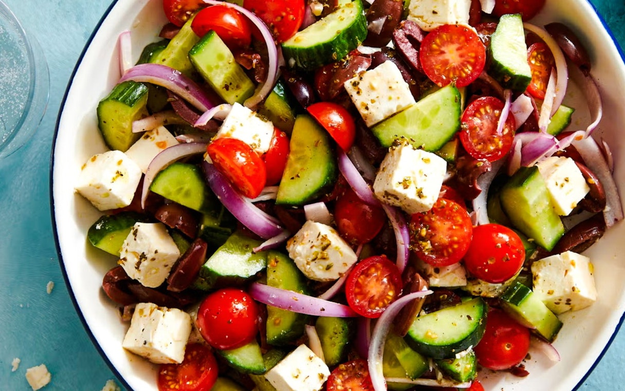 Greek salad with feta, cucumbers, tomatoes, olives, and onions served on Catamaran Cruise tour.