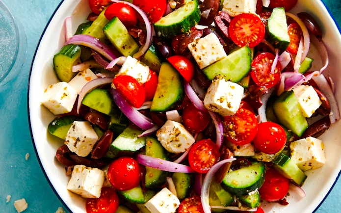 Greek salad with feta, cucumbers, tomatoes, olives, and onions served on Catamaran Cruise tour.