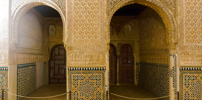 Intricate arches and tilework in the Hall of Ambassadors, Alhambra, Granada.