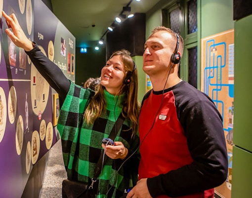 Visitors exploring Historium Bruges exhibit with optional virtual reality tour experience.