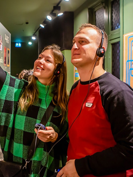 Visitors exploring exhibits at Historium Bruges with audio guides.