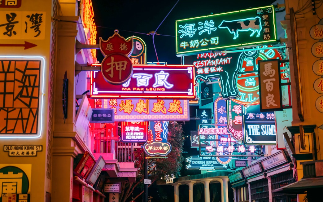 Neon signs illuminate a street at Ocean Park, Hong Kong.