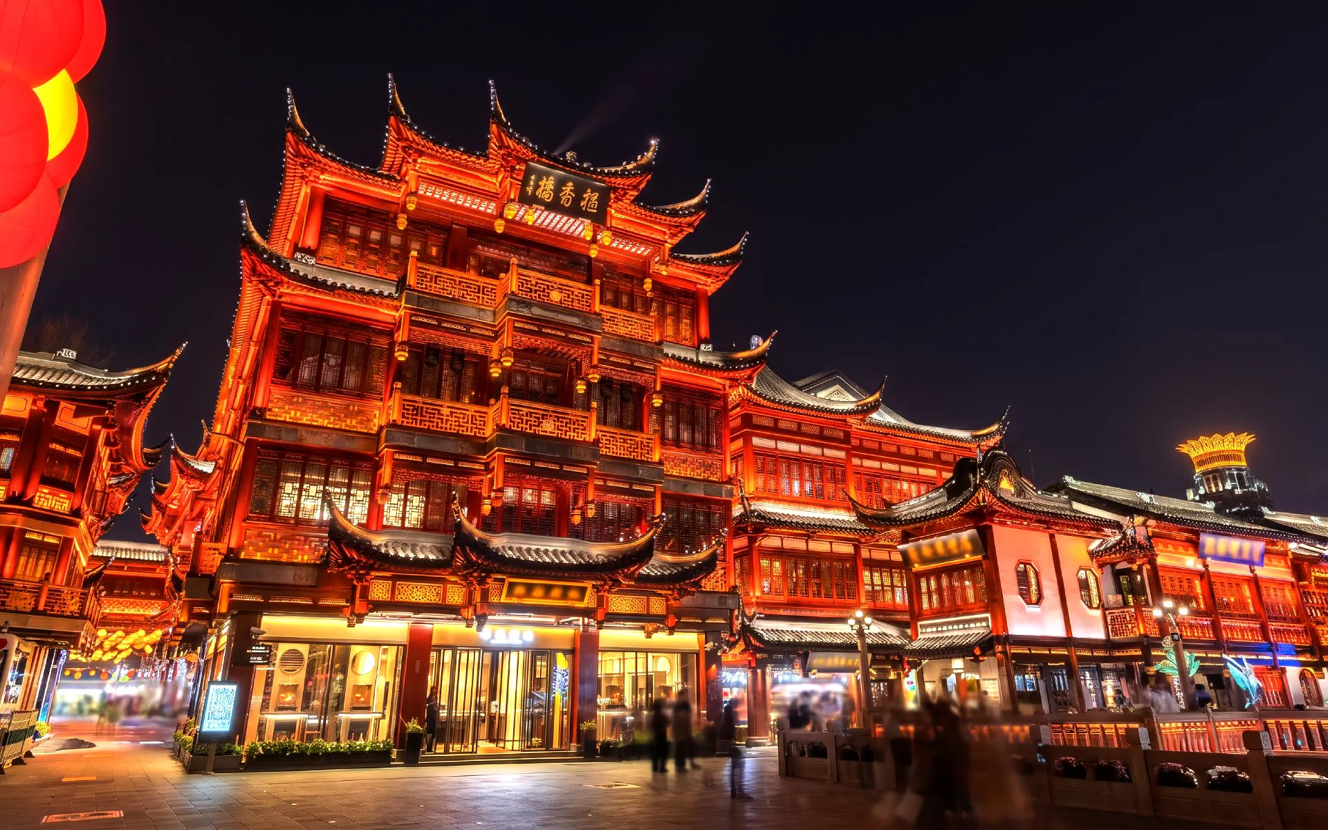Yu Garden illuminated at night, showcasing traditional Chinese architecture in Shanghai, China.