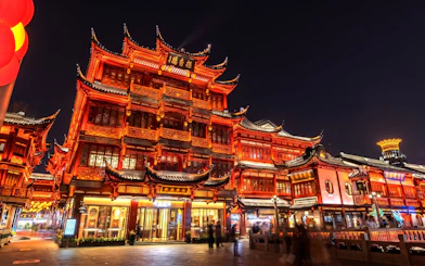 Yu Garden illuminated at night, showcasing traditional Chinese architecture in Shanghai, China.