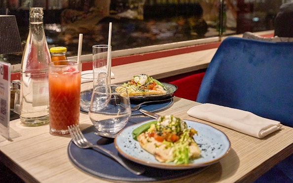 Dinner table with Italian dishes on the Théo Boat Seine River Cruise in Paris.